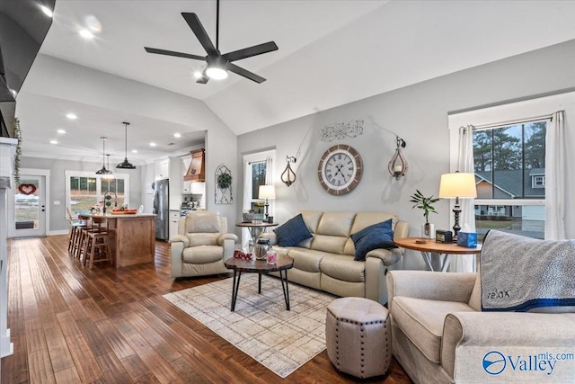 living room with hardwood / wood-style flooring, vaulted ceiling, and ceiling fan