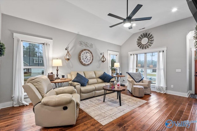 living room with ceiling fan, lofted ceiling, plenty of natural light, and wood-type flooring