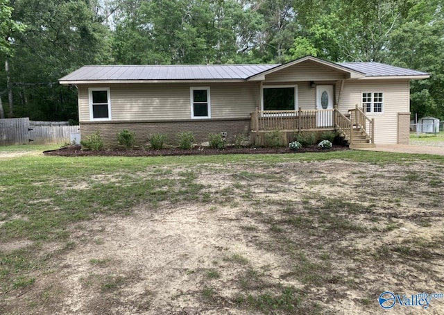 230 Hampton Rd, Hartselle, AL 35640 - ranch-style house with metal roof, view of wooded area, and brick siding