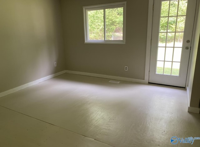 230 Hampton Rd, Hartselle, AL 35640 - spare room featuring healthy amount of natural light, baseboards, and concrete floors