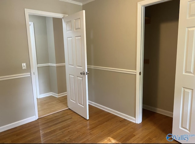 230 Hampton Rd, Hartselle, AL 35640 - unfurnished bedroom featuring wood finished floors, baseboards, and crown molding
