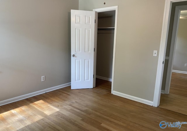 230 Hampton Rd, Hartselle, AL 35640 - unfurnished bedroom with baseboards, wood finished floors, and a closet