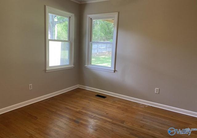 230 Hampton Rd, Hartselle, AL 35640 - spare room with baseboards, healthy amount of natural light, wood finished floors, and crown molding