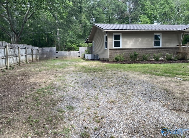 230 Hampton Rd, Hartselle, AL 35640 - view of property exterior with a fenced backyard, metal roof, and brick siding