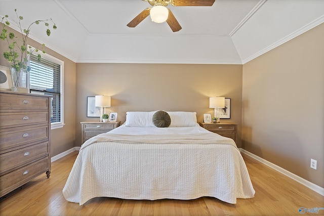 bedroom with light wood-type flooring, vaulted ceiling, ceiling fan, and crown molding