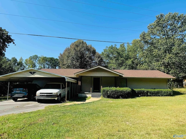 ranch-style home featuring a carport, driveway, and a front lawn