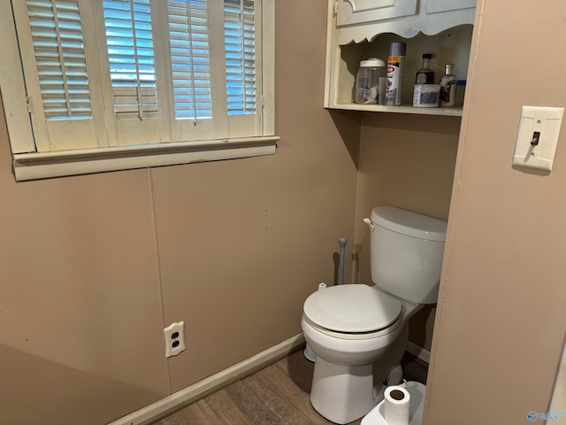 bathroom with toilet and hardwood / wood-style floors