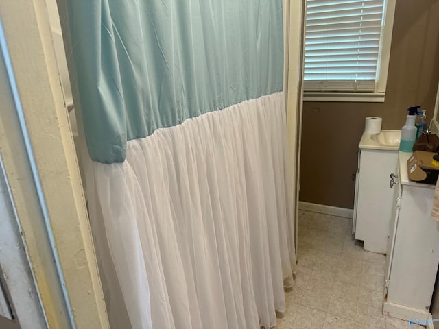 bathroom featuring baseboards, vanity, and tile patterned floors