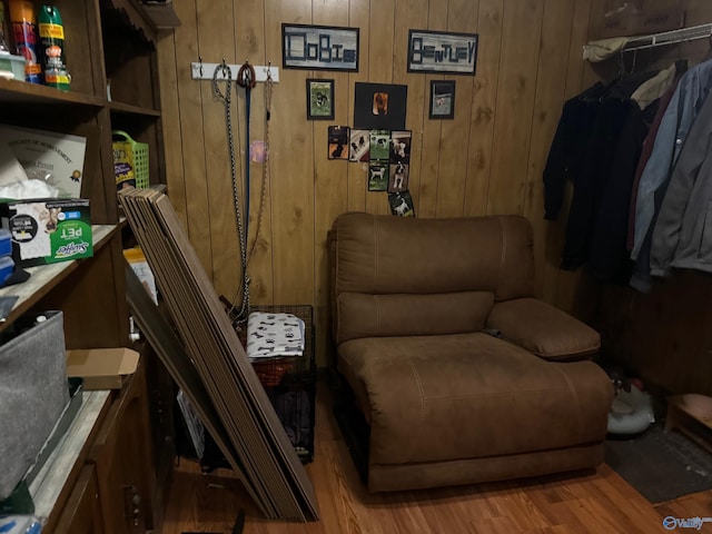 sitting room with wood walls and wood finished floors