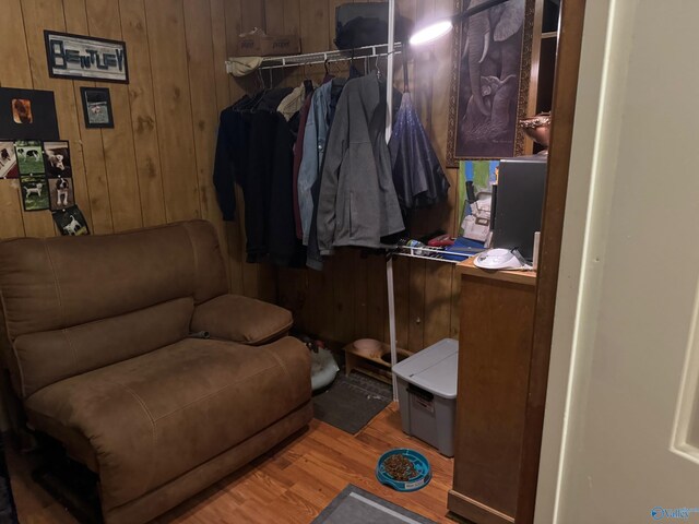 interior space with light hardwood / wood-style floors and wood walls