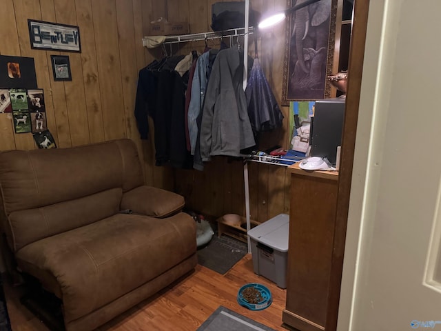 living area with wood walls and wood finished floors