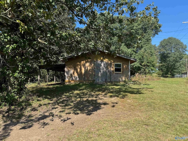 view of side of home with a lawn