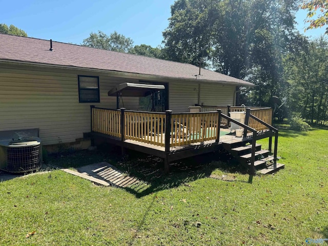 back of property featuring a wooden deck, cooling unit, and a lawn