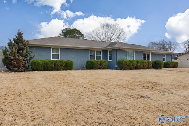 single story home featuring brick siding