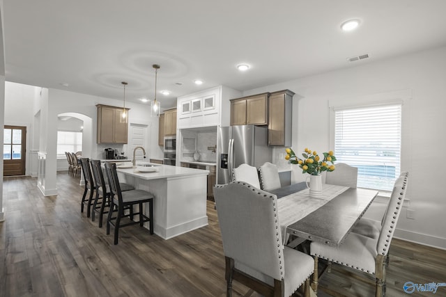 dining area featuring dark hardwood / wood-style flooring and a healthy amount of sunlight