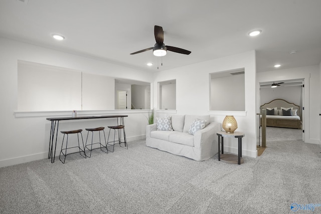 carpeted living room with ceiling fan