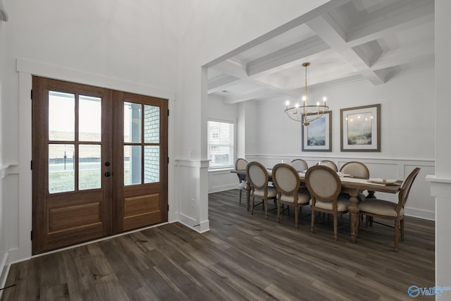 interior space with french doors, coffered ceiling, dark wood-type flooring, beam ceiling, and a notable chandelier