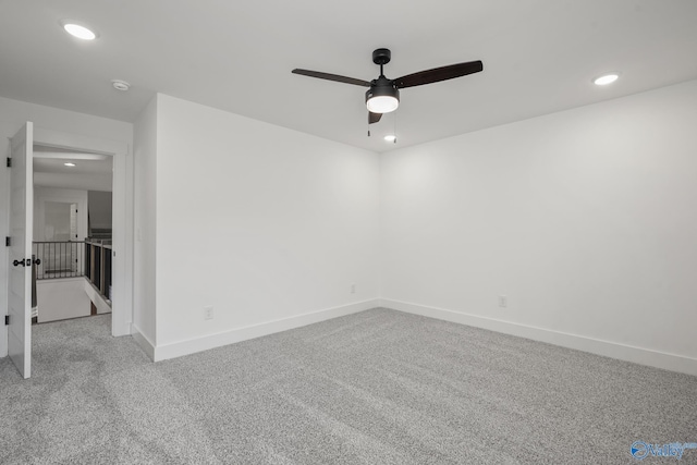 empty room with ceiling fan and light colored carpet