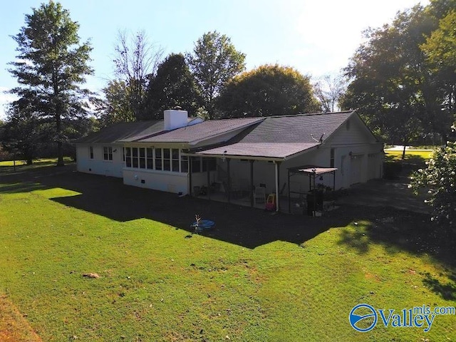 back of property featuring a lawn and a patio