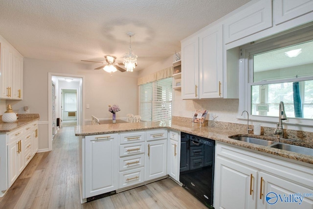 kitchen with dishwasher, kitchen peninsula, light wood-type flooring, and white cabinets