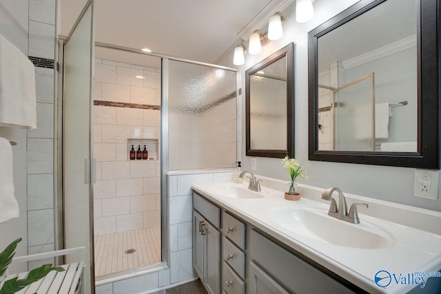 bathroom with a shower with shower door, tile walls, crown molding, and vanity