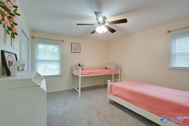 carpeted bedroom with a textured ceiling, ceiling fan, and multiple windows