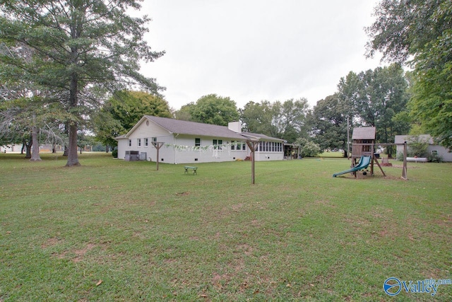 view of yard featuring central AC and a playground