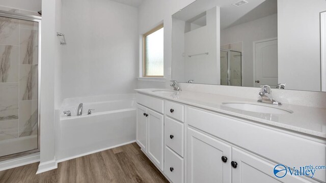 bathroom with hardwood / wood-style floors, shower with separate bathtub, and dual bowl vanity