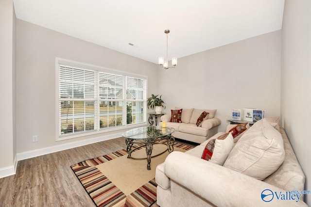 114 Burdine St, New Market, AL 35761 - living room with wood finished floors, baseboards, and a chandelier