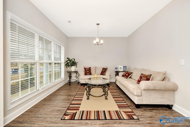 114 Burdine St, New Market, AL 35761 - living room with a chandelier, baseboards, and wood finished floors