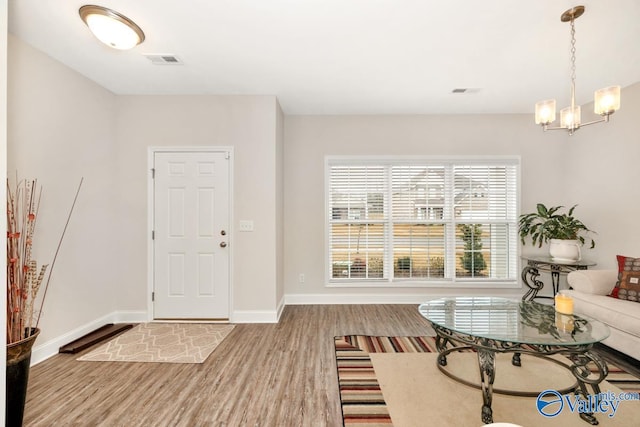 114 Burdine St, New Market, AL 35761 - entrance foyer featuring wood finished floors, baseboards, and a chandelier