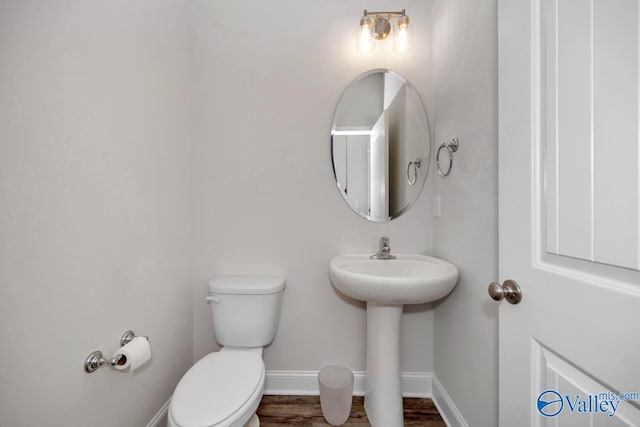 114 Burdine St, New Market, AL 35761 - bathroom with toilet, baseboards, wood finished floors, and a sink