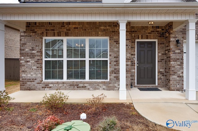 114 Burdine St, New Market, AL 35761 - view of exterior entry featuring brick siding and a porch