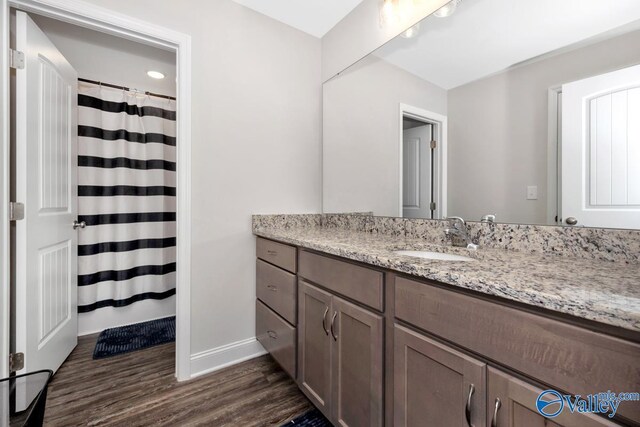 114 Burdine St, New Market, AL 35761 - bathroom featuring wood finished floors, vanity, baseboards, and a shower with shower curtain