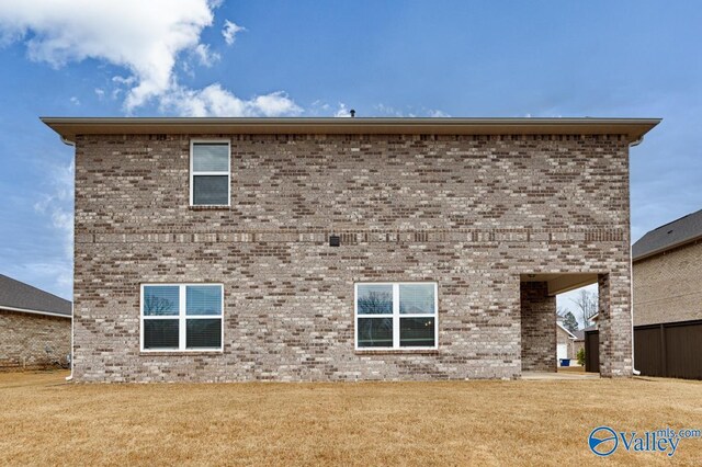 114 Burdine St, New Market, AL 35761 - back of house featuring brick siding and a lawn