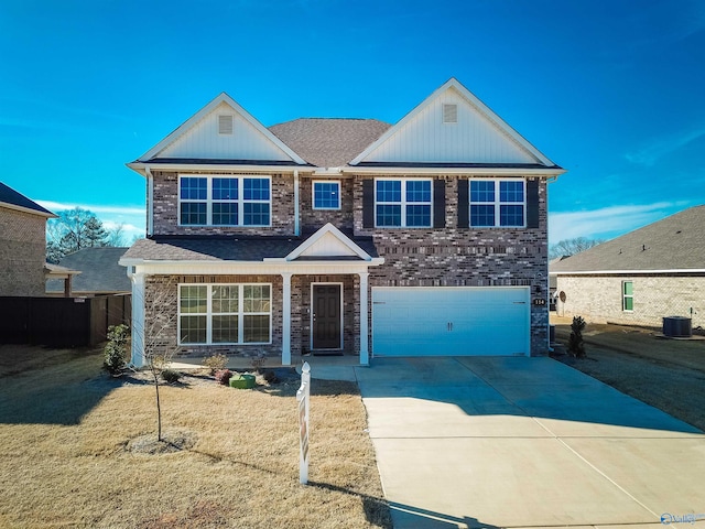 114 Burdine St, New Market, AL 35761 - traditional-style house with an attached garage, driveway, central AC unit, and brick siding