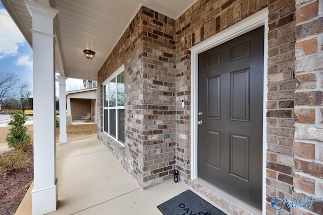 114 Burdine St, New Market, AL 35761 - doorway to property featuring a porch and brick siding