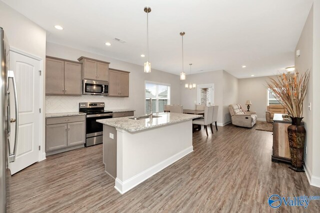 114 Burdine St, New Market, AL 35761 - kitchen with appliances with stainless steel finishes, a sink, wood finished floors, decorative backsplash, and recessed lighting