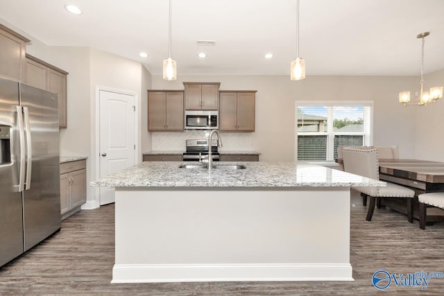 114 Burdine St, New Market, AL 35761 - kitchen featuring appliances with stainless steel finishes, a sink, wood finished floors, backsplash, and recessed lighting