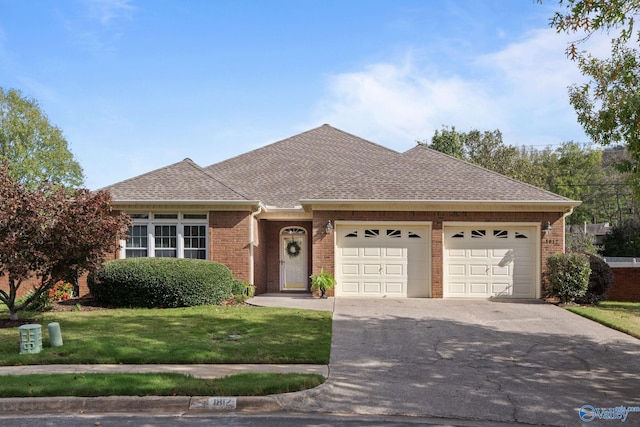 single story home with a garage and a front lawn