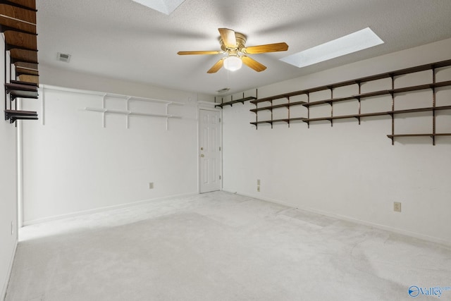 carpeted empty room featuring a textured ceiling and ceiling fan