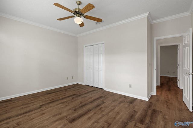 unfurnished bedroom with a closet, ceiling fan, crown molding, and dark hardwood / wood-style flooring