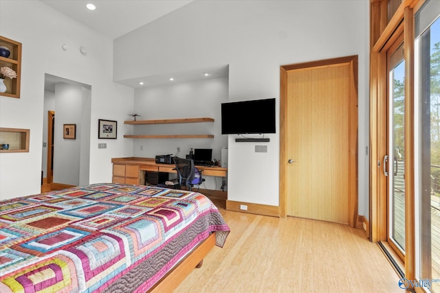 bedroom featuring built in desk, light wood-type flooring, access to outside, and high vaulted ceiling