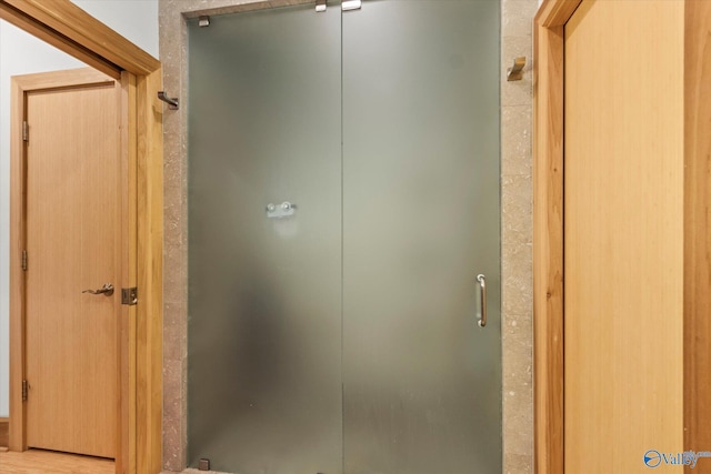 bathroom with a shower with shower door