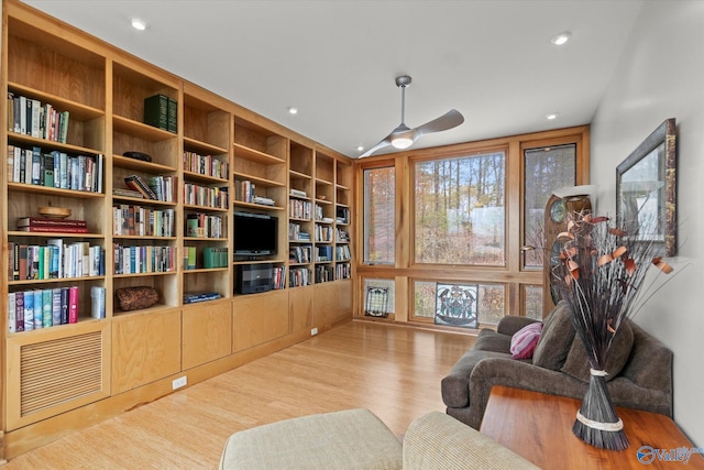 living area featuring ceiling fan, a healthy amount of sunlight, and light wood-type flooring