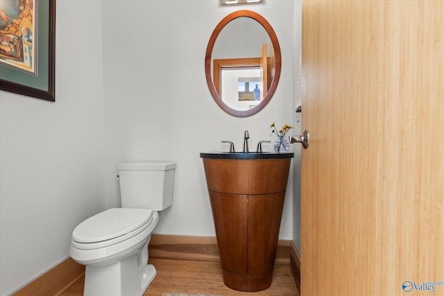 bathroom featuring hardwood / wood-style floors, vanity, and toilet