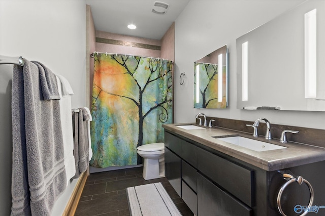 bathroom with a shower with curtain, tile patterned flooring, vanity, and toilet