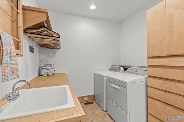 washroom with washer and clothes dryer and sink