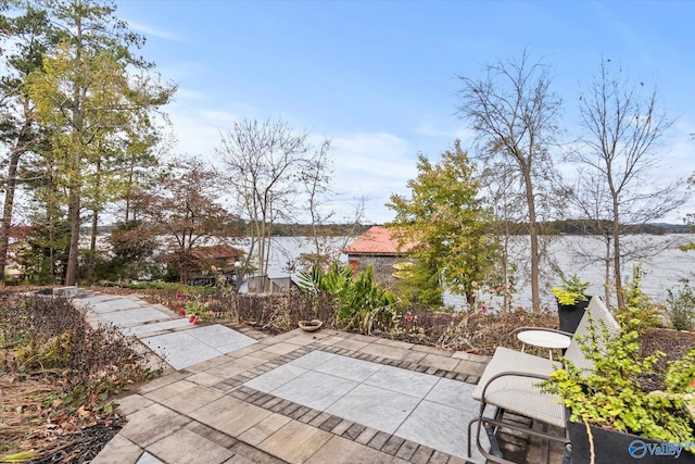 view of patio with a water view