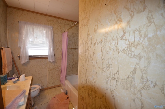 bathroom with vanity, baseboards, shower / bath combination with curtain, crown molding, and toilet